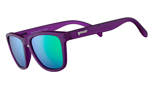 Dreiviertelansicht einer quadratischen Sonnenbrille mit lilafarbenem Rahmen und grün verspiegelten, polarisierten Gläsern.